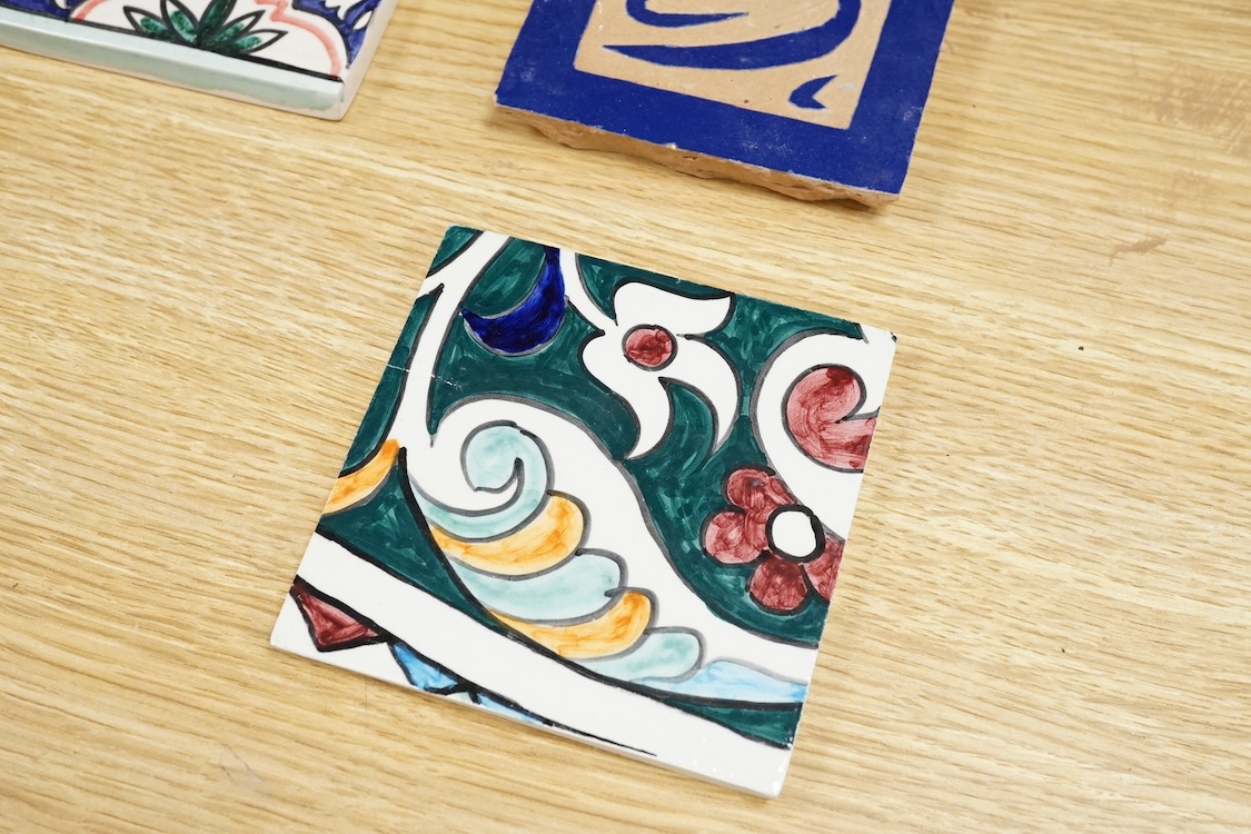 A Berber sixteen tile set, North African to read 'God is Great', floral tiles 10cm square